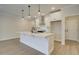 Bright kitchen features a quartz island, stainless steel appliances, and modern pendant lighting at 4517 Twinberry Dr, Powder Springs, GA 30127