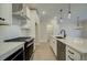 Modern kitchen featuring white cabinets, stainless steel appliances, and a spacious island at 4517 Twinberry Dr, Powder Springs, GA 30127