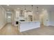 Modern kitchen with a white island, chic pendant lighting, and stainless steel appliances at 4517 Twinberry Dr, Powder Springs, GA 30127