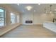 Bright living room showcasing an electric fireplace and an open kitchen with quartz island at 4517 Twinberry Dr, Powder Springs, GA 30127