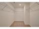 Walk-in closet with wire shelving and neutral carpet at 4517 Twinberry Dr, Powder Springs, GA 30127