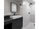 Modern bathroom featuring sleek black and white design with stylish fixtures and a walk-in shower at 5020 Vallo Vista Ct, Atlanta, GA 30342
