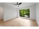 Bright bedroom with hardwood floors, a modern ceiling fan, and a large window at 5020 Vallo Vista Ct, Atlanta, GA 30342