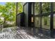 Modern home featuring a wood deck and large windows with natural light and views at 5020 Vallo Vista Ct, Atlanta, GA 30342