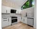 Modern kitchen featuring white cabinets, granite countertops, stainless steel appliances, and a bright, airy atmosphere at 5020 Vallo Vista Ct, Atlanta, GA 30342