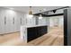 Contemporary kitchen with a central island, ample cabinet space, and sleek lighting fixtures for a modern look at 5020 Vallo Vista Ct, Atlanta, GA 30342