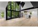 Bright, spacious living room boasting high ceilings, expansive windows with views, and an open-concept layout at 5020 Vallo Vista Ct, Atlanta, GA 30342