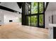 Modern living room featuring a stone fireplace, large windows with a view, and sleek design elements at 5020 Vallo Vista Ct, Atlanta, GA 30342