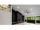 Bright living room with sleek black fireplace, fan, light wood floors and stained glass accent window at 5020 Vallo Vista Ct, Atlanta, GA 30342