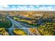 Overhead view of a highway interchange and a planned community nestled among lush greenery and trees at 553 Princeton Elm Place Way, Lawrenceville, GA 30045
