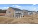 New construction home showcasing a spacious backyard, patio, and a mix of brick and siding exterior at 553 Princeton Elm Place Way, Lawrenceville, GA 30045