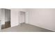 View of a bedroom with neutral walls, carpet, and a view to a walk-in closet at 553 Princeton Elm Place Way, Lawrenceville, GA 30045