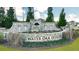 Stone entrance sign for Water Oak Estates with decorative landscaping and established trees at 553 Princeton Elm Place Way, Lawrenceville, GA 30045