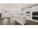 An open kitchen offers modern appliances, an island and access to a dining or living area at 553 Princeton Elm Place Way, Lawrenceville, GA 30045