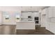 An open kitchen offers modern appliances, an island and access to a dining or living area at 553 Princeton Elm Place Way, Lawrenceville, GA 30045