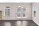 Bright living room with hardwood flooring, stone fireplace, and abundant natural light at 553 Princeton Elm Place Way, Lawrenceville, GA 30045
