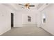 Large main bedroom with a tray ceiling, multiple windows, and neutral carpet at 553 Princeton Elm Place Way, Lawrenceville, GA 30045