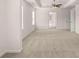 Spacious main bedroom featuring a tray ceiling, carpet, ceiling fan and bright windows at 553 Princeton Elm Place Way, Lawrenceville, GA 30045