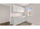 Pantry featuring white cabinets, granite countertops, tile flooring, and a window for natural light at 553 Princeton Elm Place Way, Lawrenceville, GA 30045