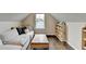 Cozy bonus room features a comfortable seating area, wood floors, and shelving filled with colorful books at 6468 Pierless Ave, Sugar Hill, GA 30518