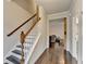 Welcoming entryway with hardwood floors, staircase, and a glimpse into the living room area at 6468 Pierless Ave, Sugar Hill, GA 30518