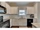 Bright kitchen with white cabinets, black appliances, granite countertops, and subway tile backsplash at 6468 Pierless Ave, Sugar Hill, GA 30518