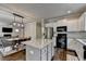 Open-concept kitchen with an island flowing into the dining area, perfect for entertaining guests at 6468 Pierless Ave, Sugar Hill, GA 30518