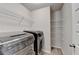 The laundry room is equipped with modern washer and dryer units plus shelving at 6468 Pierless Ave, Sugar Hill, GA 30518