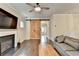 Cozy living room with a fireplace, sliding barn door, hardwood floors, and comfortable seating at 6468 Pierless Ave, Sugar Hill, GA 30518