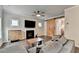 Bright living room showcasing a fireplace, mounted TV, barn door, hardwood floors, and neutral decor at 6468 Pierless Ave, Sugar Hill, GA 30518