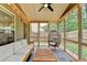 Relaxing screened-in porch featuring stylish furniture, string lights, and views of the lush backyard at 6468 Pierless Ave, Sugar Hill, GA 30518