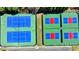 Overhead shot of a tennis court complex featuring pristine blue and red courts and perimeter seating at 6468 Pierless Ave, Sugar Hill, GA 30518