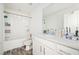 Bright bathroom with white vanity, grey vinyl flooring and shower-tub combo at 875 Venture Sw Way, Atlanta, GA 30331