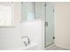 Bright bathroom featuring a glass-enclosed shower and a separate bathtub at 875 Venture Sw Way, Atlanta, GA 30331