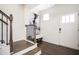 Welcoming foyer with hardwood floors, staircase, and a modern art piece enhancing the entryway's appeal at 875 Venture Sw Way, Atlanta, GA 30331