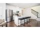 Modern kitchen with white cabinets, stainless steel appliances, quartz countertops, and a stylish island with seating at 875 Venture Sw Way, Atlanta, GA 30331
