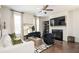 Bright living room with a fireplace, large TV, comfortable seating, and stylish decor at 875 Venture Sw Way, Atlanta, GA 30331