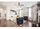 Bright living room featuring hardwood floors, a ceiling fan, modern furniture, and large windows at 875 Venture Sw Way, Atlanta, GA 30331