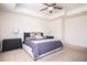 Spacious main bedroom with a tray ceiling, ceiling fan, neutral decor, and two nightstands at 875 Venture Sw Way, Atlanta, GA 30331