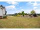 Large backyard featuring landscaped bushes and trees, with a fence separating the yard at 170 Oakleigh Manor Dr, Fayetteville, GA 30215