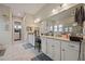 Bright bathroom features a large mirror, granite countertops, and access to closet at 170 Oakleigh Manor Dr, Fayetteville, GA 30215