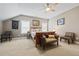Bedroom with neutral carpet, a ceiling fan, and various chairs and decoration at 170 Oakleigh Manor Dr, Fayetteville, GA 30215