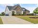 Lovely home with a long driveway and manicured lawn with a two car garage at 170 Oakleigh Manor Dr, Fayetteville, GA 30215