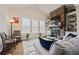 Cozy living room featuring stone fireplace, built-in bookshelves and lots of natural light at 170 Oakleigh Manor Dr, Fayetteville, GA 30215