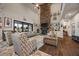 Spacious living room featuring a soaring ceiling, hardwood floors, and stone fireplace at 170 Oakleigh Manor Dr, Fayetteville, GA 30215