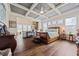 Luxurious main bedroom with trey ceilings, wood floors, and views of the living room at 170 Oakleigh Manor Dr, Fayetteville, GA 30215