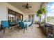 Inviting covered patio with ceiling fan, dining table, and tranquil backyard views at 170 Oakleigh Manor Dr, Fayetteville, GA 30215