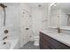 A bathroom featuring marble tile, a dark vanity, and bronze fixtures at 220 Semel Cir # 150, Atlanta, GA 30309