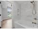 This bathroom includes a jacuzzi tub with marble backsplash and bronze fixtures at 220 Semel Cir # 150, Atlanta, GA 30309