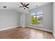 This spacious bedroom features a large window, ceiling fan, and hardwood floors at 220 Semel Cir # 150, Atlanta, GA 30309